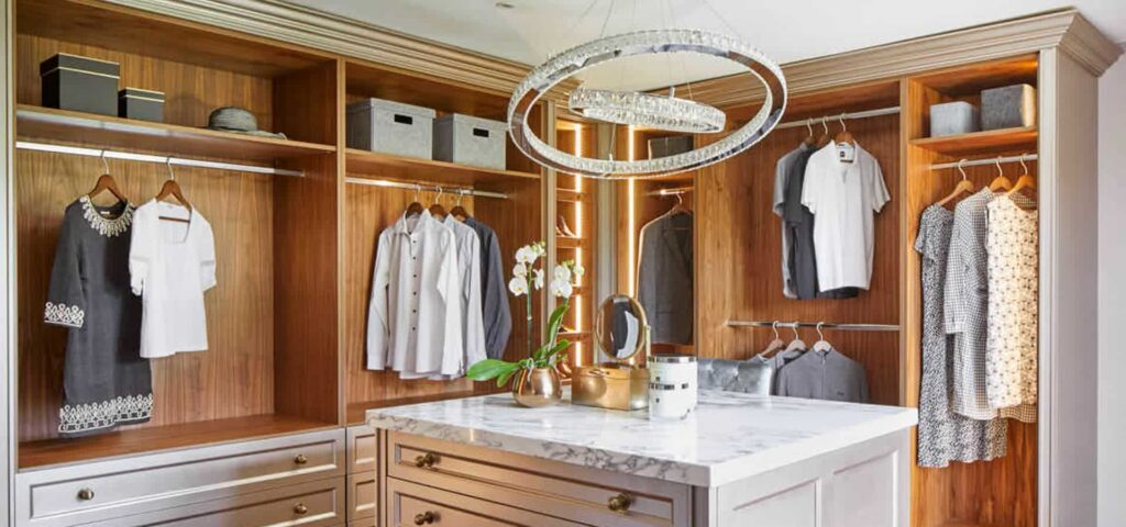 An elegant dressing room with cabinets and a white marble countertop