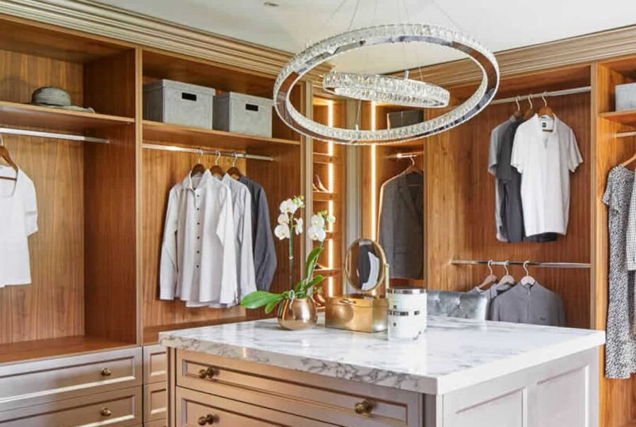 An elegant dressing room with cabinets and a white marble countertop