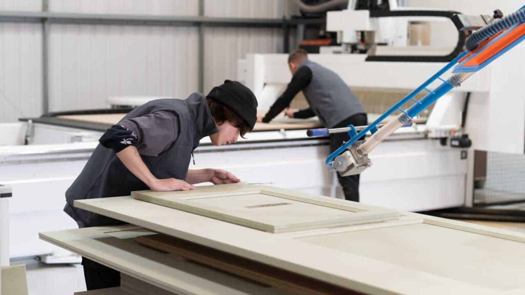 A craftsman working on a piece of wood for a wardrobe