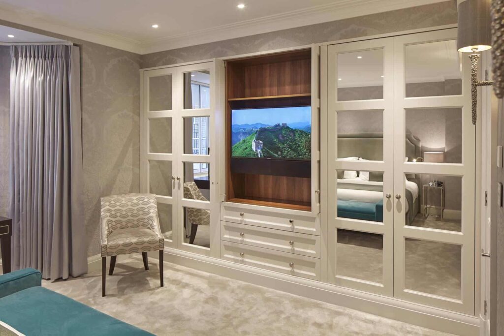 A sophisticated fitted wardrobe with Windsor mirrored panels and classic Edwardian designs