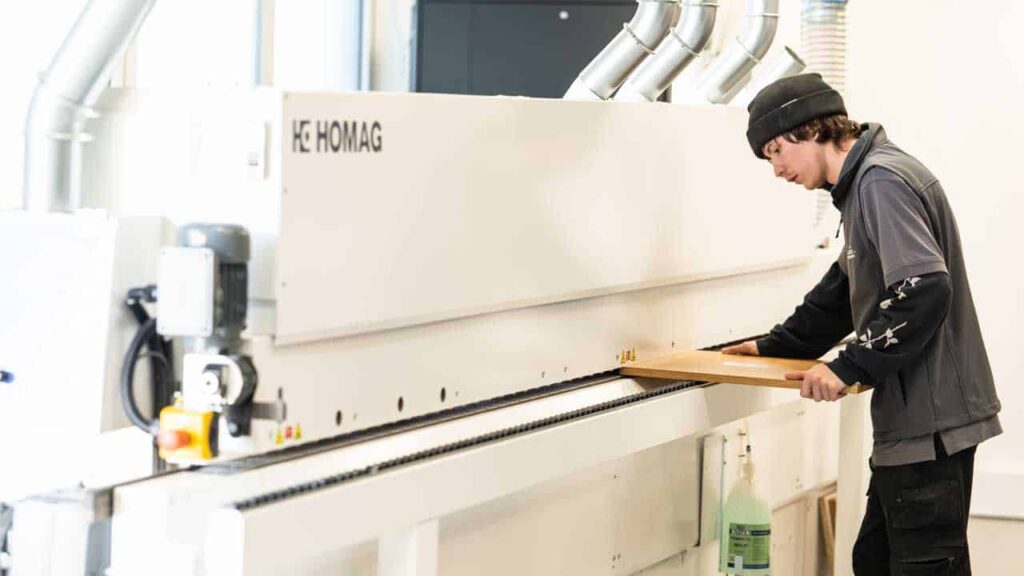 A person operating a machine for crafting a wardrobe