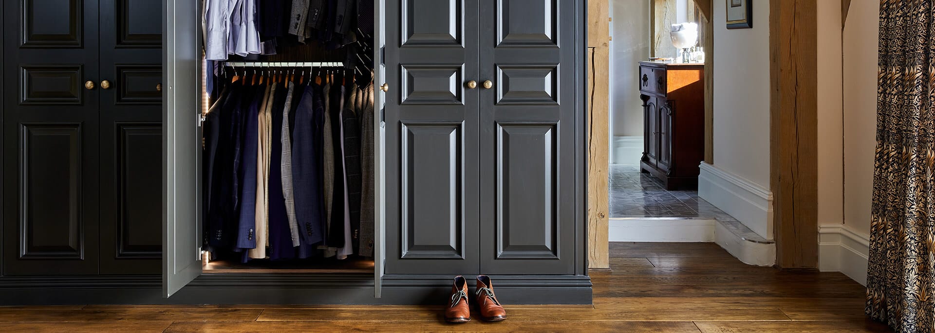 Bespoke dark luxury wardrobe with clothing and shoes