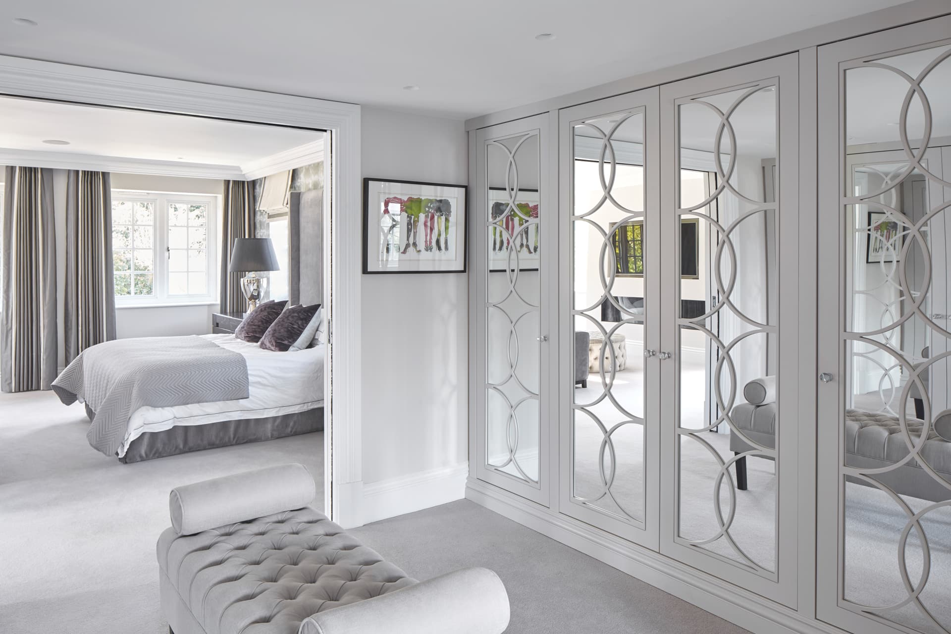 Well-organised walk-in wardrobe with mirrored doors