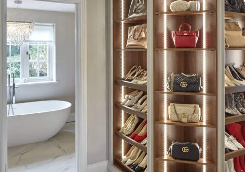 Rebecca Doyle's open walnut shoe and handbag storage.