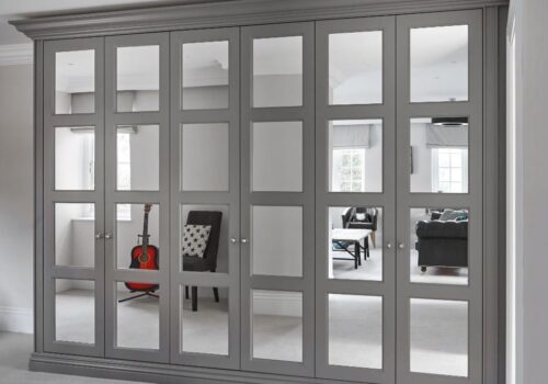 Bespoke built-in wardrobes with a large closet with glass doors