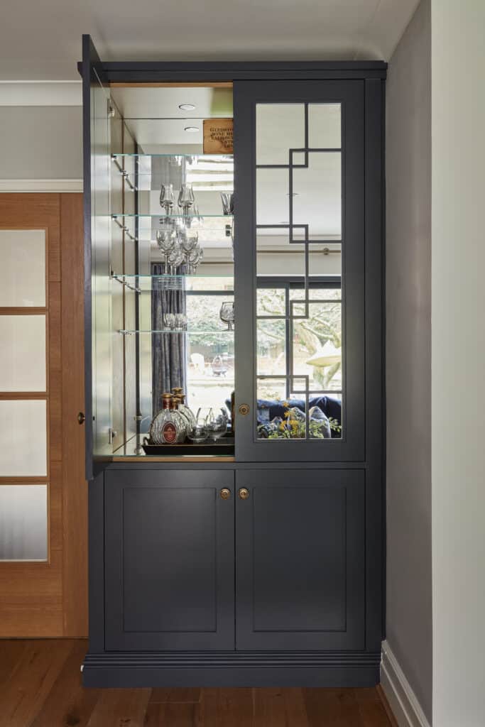 Woking - Wilson 11 Close-up of mirrored Wentworth fitted display cabinet with door open