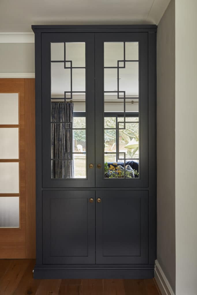 Woking - Wilson 12 Close-up of mirrored Wentworth fitted display cabinet in dark blue