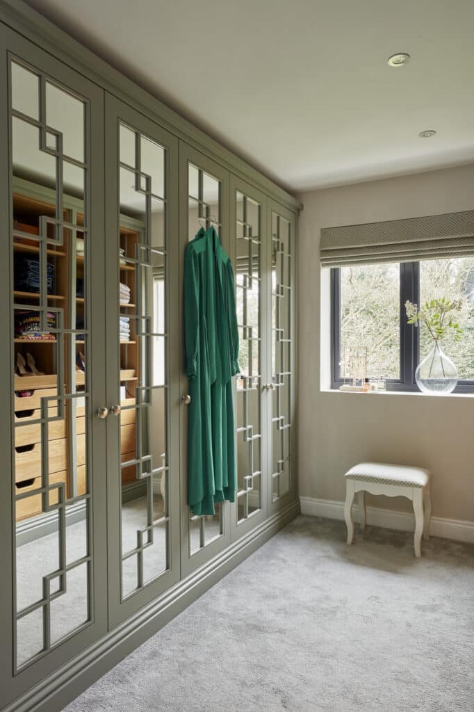 White mirrored Wentworth fitted wardrobe with green dress hanging
