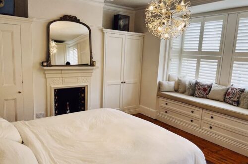 White Tilford fitted wardrobes built around chimney and fireplace