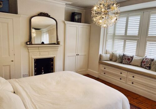 White Tilford fitted wardrobes built around chimney and fireplace