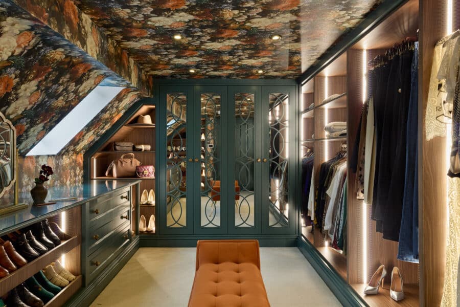 bespoke loft conversion into luxury dressing room. Including vibrant floral wallpaper, dark green wardrobes with mirrored doors and soft LED lighting