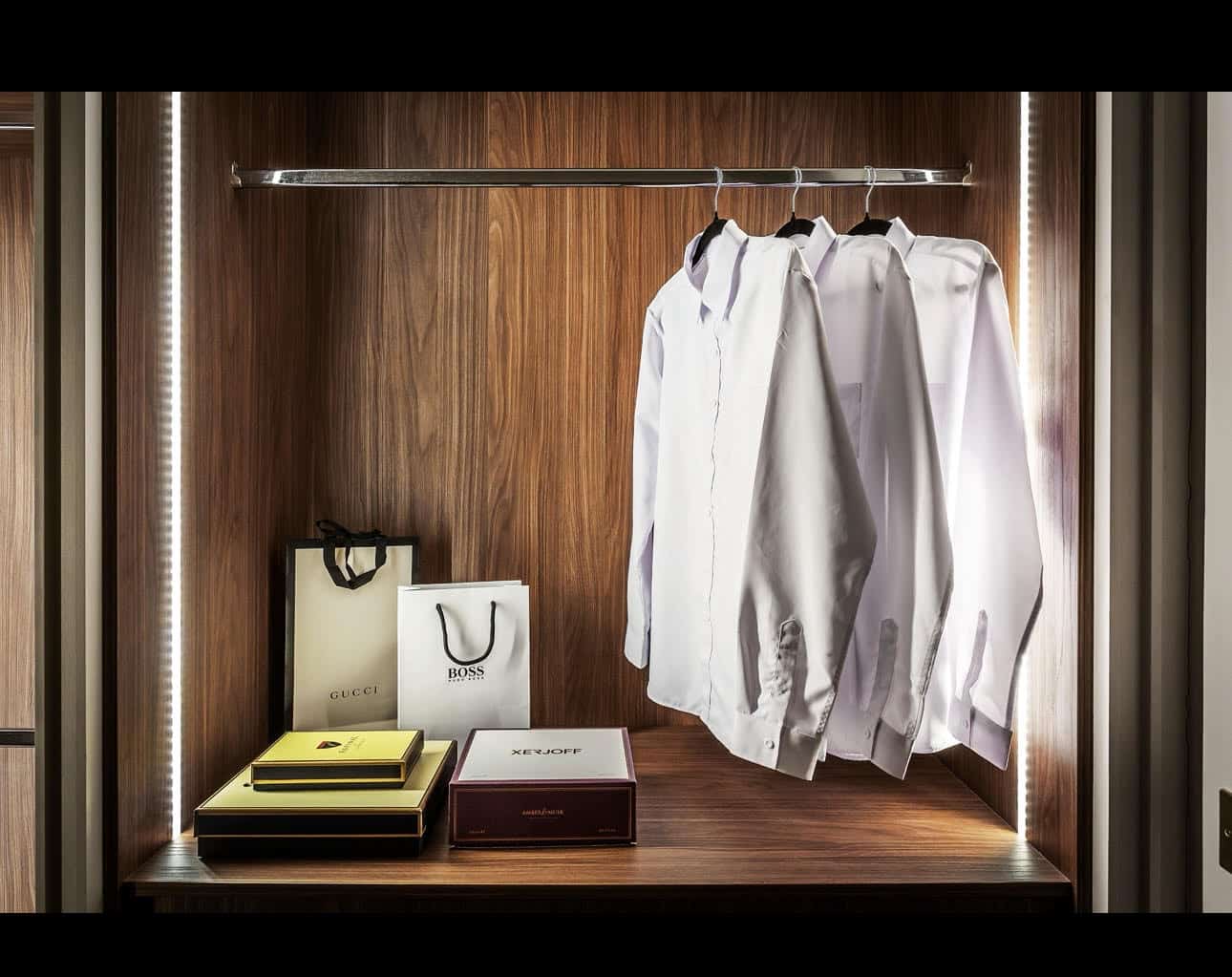 Luxury fitted wardrobe with LED lighting, designer shirts and designer branded bags