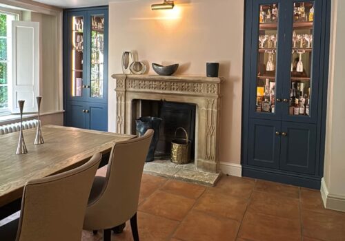 Illuminated built-in drinks cabinet in dark blue