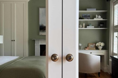 fitted wardrobe and bookcase reflected in fitted wardrobe mirrored doors