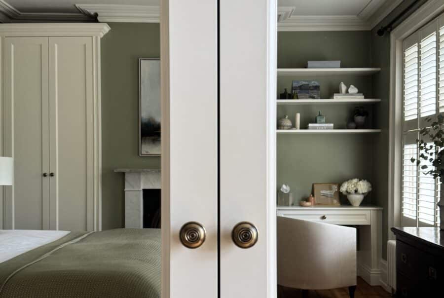 Classic style fitted wardrobe reflected in mirrored wardrobe door